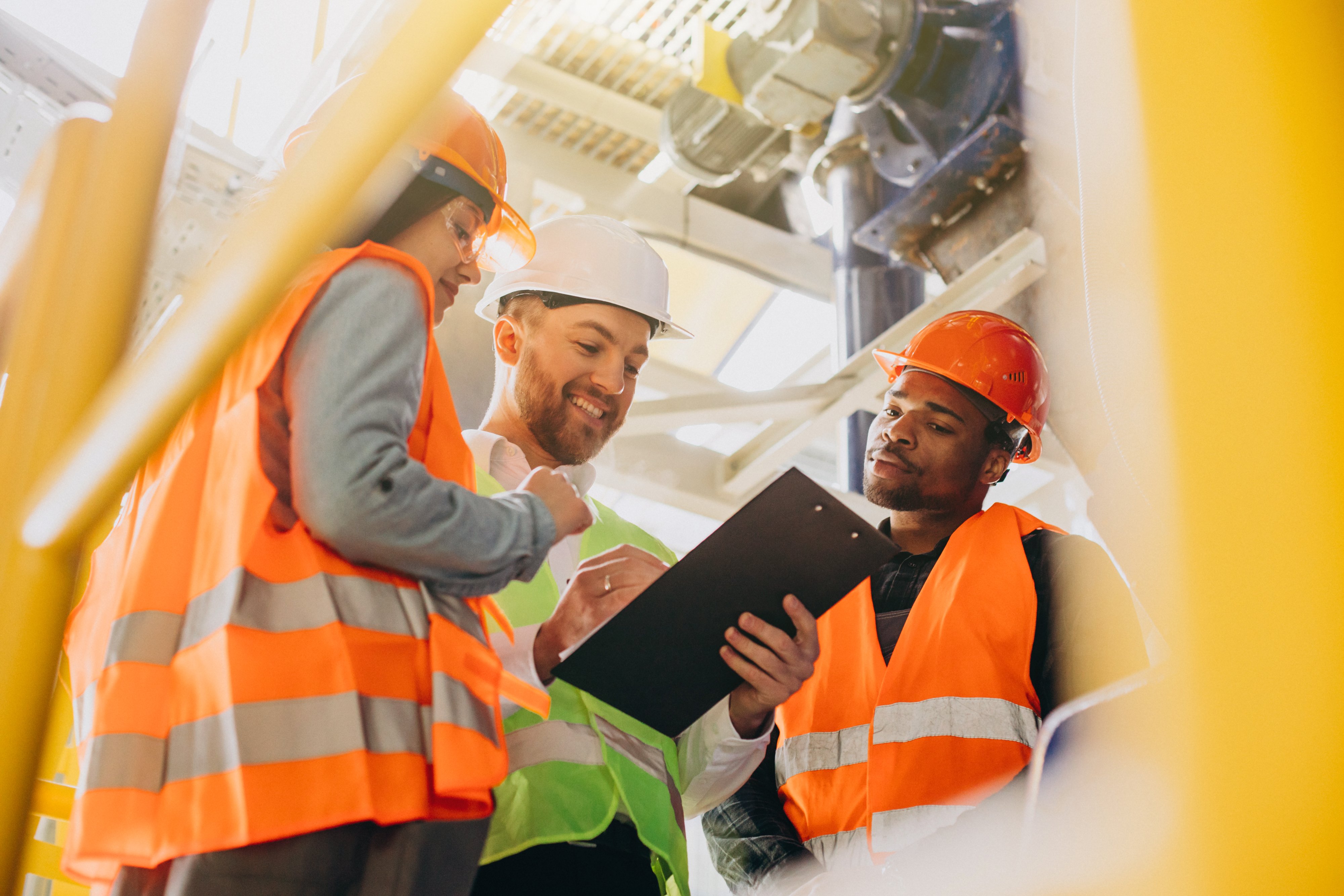 three-people-discussing-plan-factory